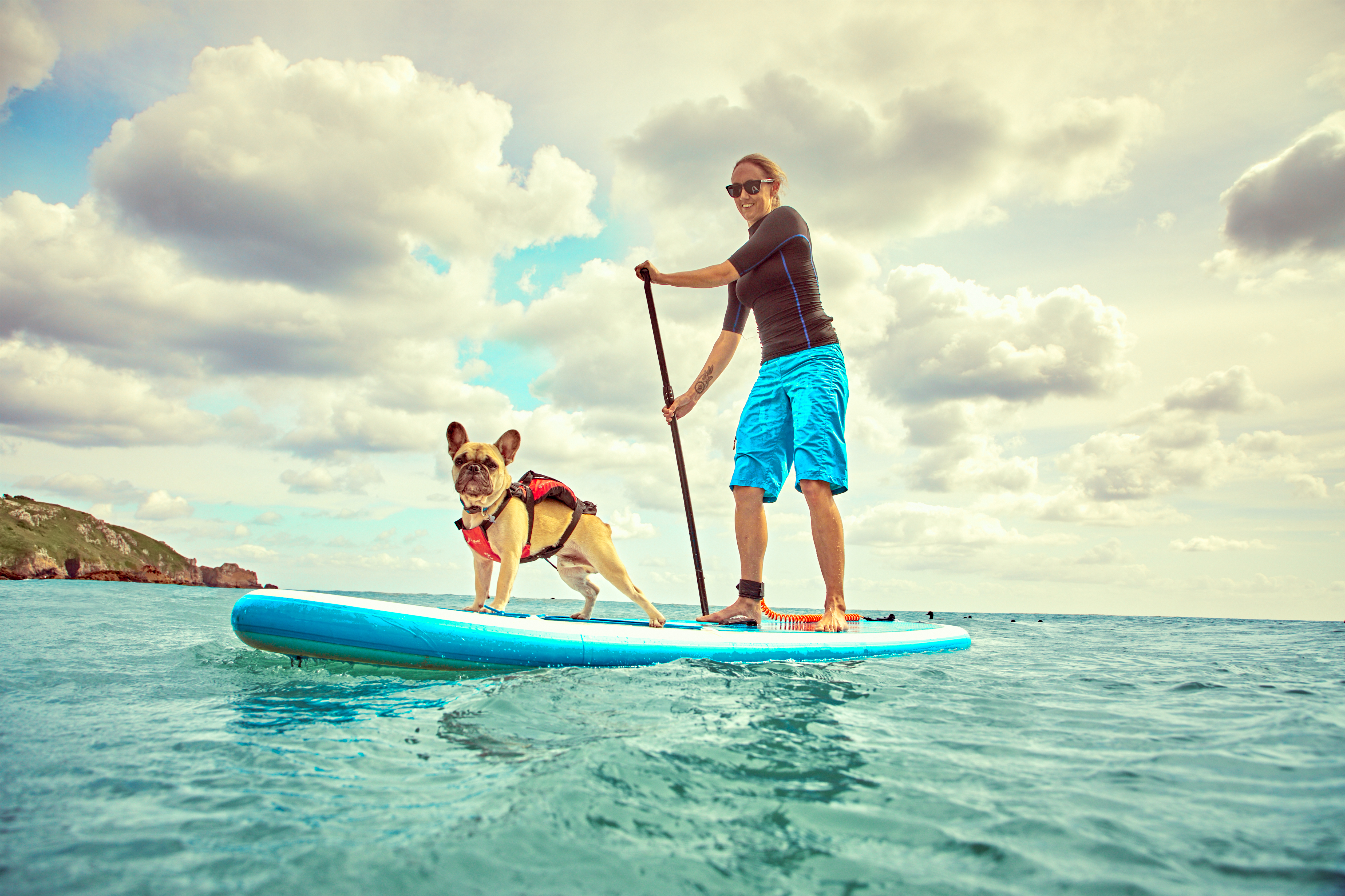 Lady Paddleboarding With her Dog 